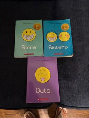 Scholastic books in teal, blue, and purple
